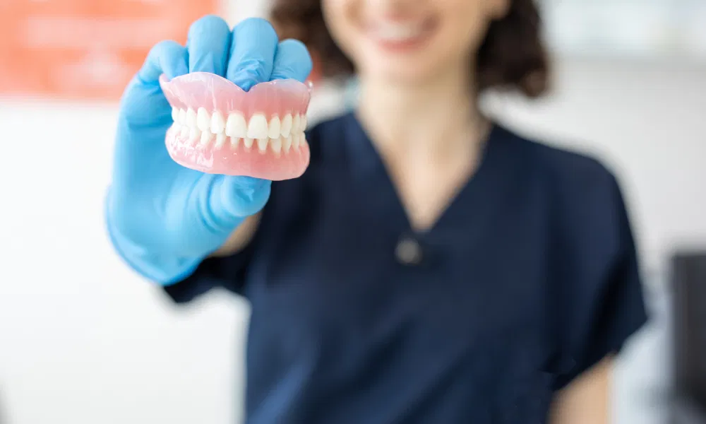 Dentist Holding Full Dentures - Serenity Valley Family Dentistry