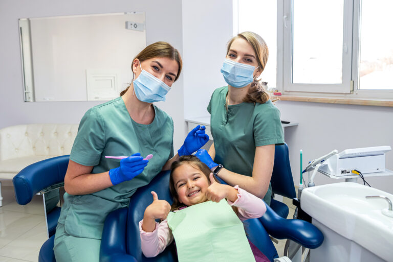 Dental team member gently examining a young patient during a comfortable, patient sedation dentistry visit