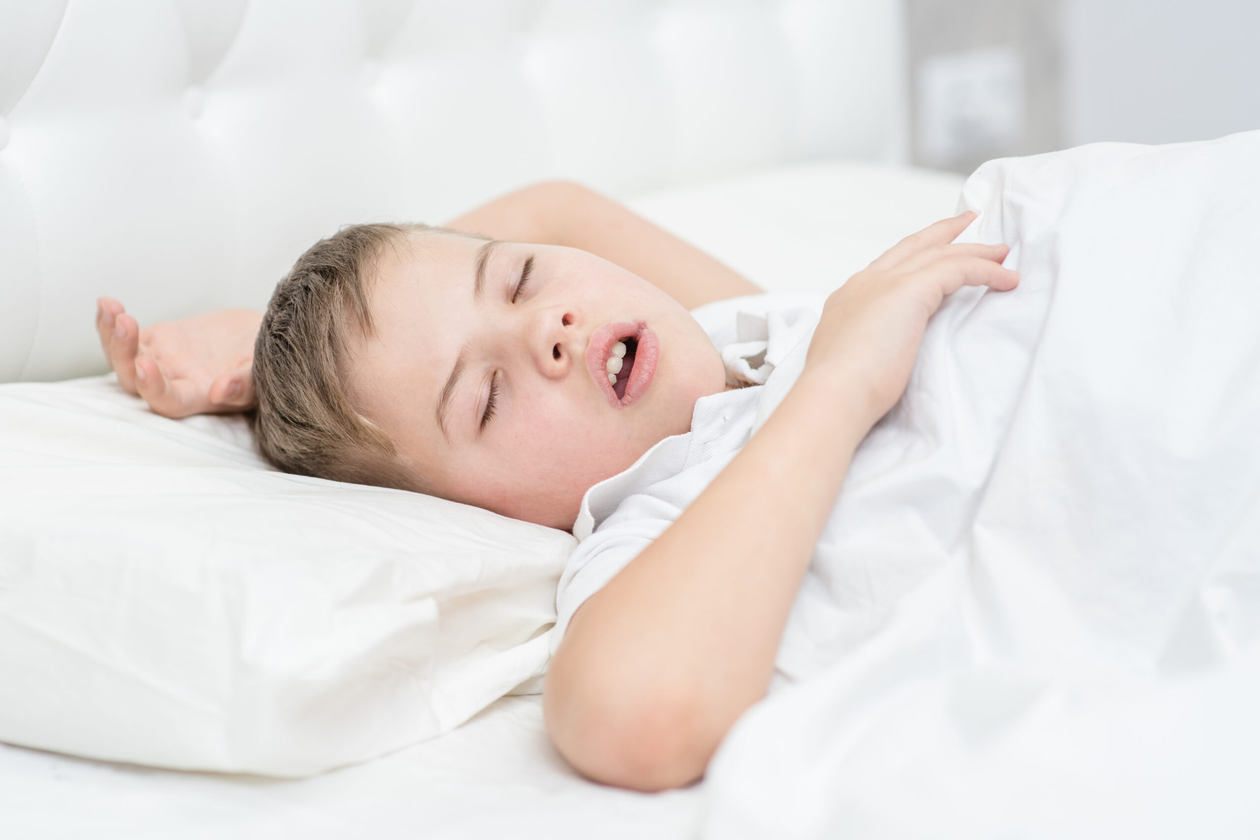 Young child sleeping with mouth open due to mouth breathing